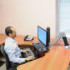 WorkFit-A sit-to-stand desk with suspended keyboard tray and LCD monitor, promoting healthy work habits.