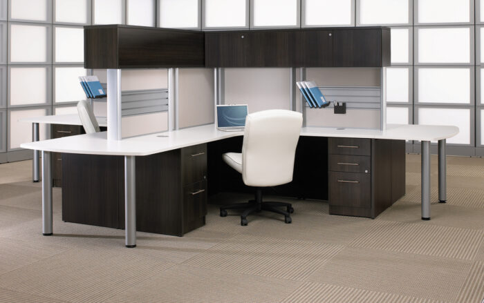 Metropolis executive office with L-shaped desk, comfortable chairs, and ample storage space in rich wood finish.