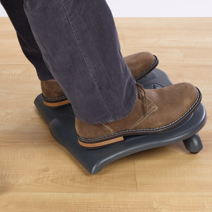 Kensington SoleSaver Footrest in use at a desk: Promotes better circulation and reduces strain on lower back while working.