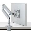 The M2.1 Radial Monitor Arm attached to a desk, holding a computer monitor.