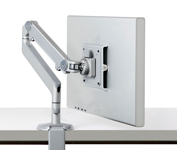 The M2.1 Radial Monitor Arm attached to a desk, holding a computer monitor.