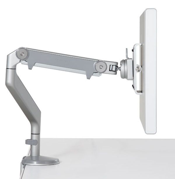 The M2.1 Radial Monitor Arm mounted to a desk with the included desk clamp.