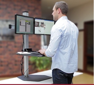 The Winston Sit Stand Workstation in its highest position, allowing the user to stand and work comfortably.