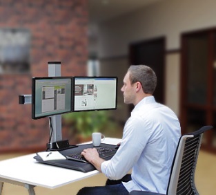 The Winston Sit Stand Workstation in its lowest position, providing a comfortable sitting position for the user.