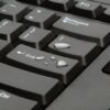 Kensington Keyboard for Life being tested with a spill of water to demonstrate its spill-proof feature.